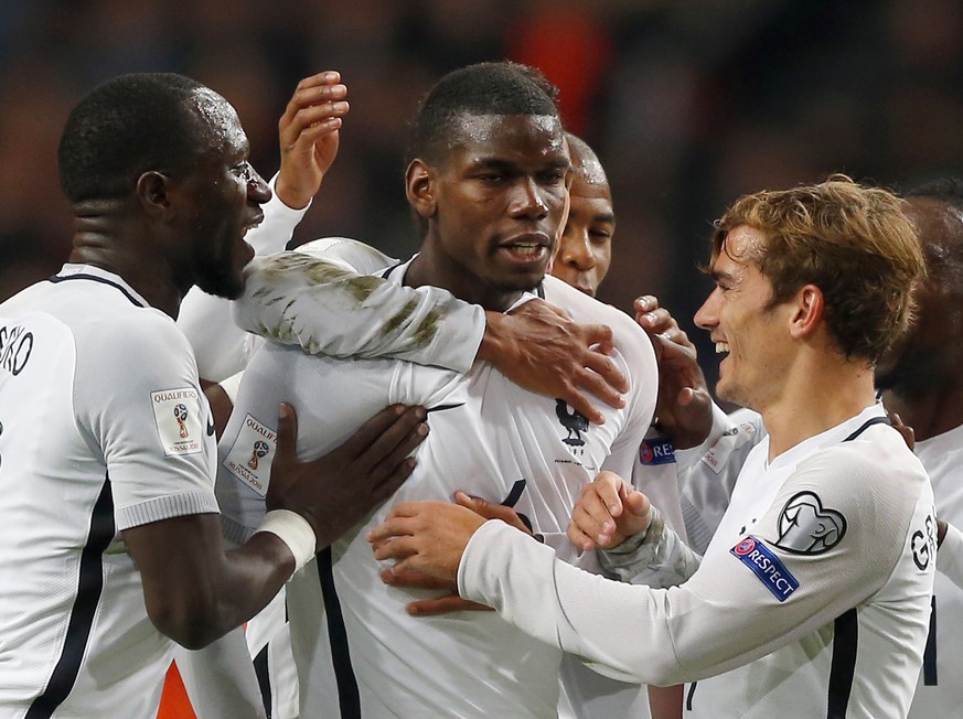 France&#039;s Paul Pogba, center, is congratulated by teammates after scoring the opening goal during the World Cup Group A qualifying soccer match in the ArenA stadium in Amsterdam, Netherlands, Mond ...