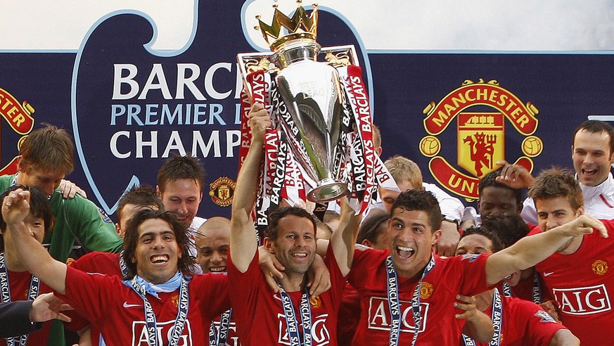 FILE - In this Sunday, May 11, 2008 file photo, Manchester United&#039;s, Ryan Giggs, center, lifts the trophy as his team celebrate winning the English Premier League after their 2-0 win against Wiga ...