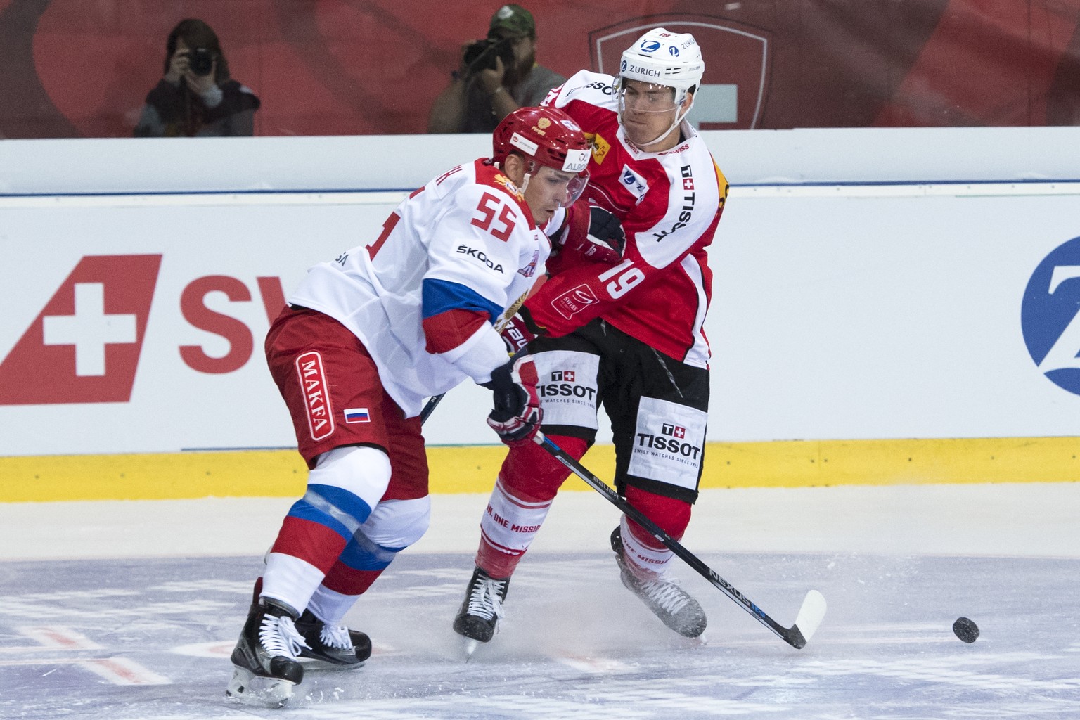 CAPTION CORRECTION: CORRECTS NAME - Russia&#039;s Bogdan Kiselevich, left, and Switzerland&#039;s Reto Schaeppi, right, in action during a friendly ice hockey game between Switzerland and Russia, at t ...