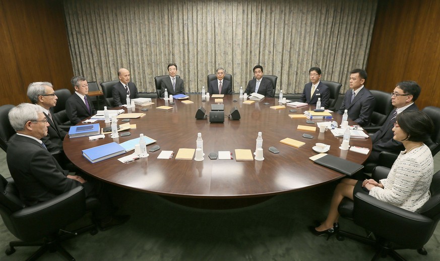 Governor of the Bank of Japan Haruhiko Kuroda, center back, poses with other members of Policy Board of the BOJ before their meeting at its headquarters in Tokyo Friday, July 29, 2016. Japan&#039;s ce ...