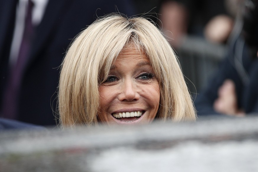 epa05948142 French presidential election candidate for the &#039;En Marche!&#039; (Onwards!) political movement, Emmanuel Macron&#039;s wife Brigitte Trogneux smiles to people as she leaves the pollin ...