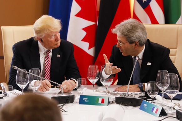 President Donald Trump listens to Italian Prime Minister Paolo Gentiloni as they sit around a table during the G7 Summit in Taormina, Sicily, Italy, Friday, May 26, 2017. (Jonathan Ernst/Pool Photo vi ...