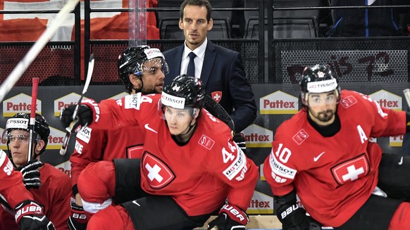 Patrick Fischer, head coach of Switzerland national ice hockey team, center, looks on during their Ice Hockey World Championship group B preliminary round match between Switzerland and Slovenia in Par ...