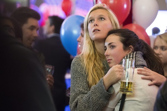 epa05623639 Two people react during an election party organized by the US embassy at the Kornhaus Cafe, Bern, Switzerland, 09 November 2016. US Americans vote on Election Day to choose the 45th Presid ...