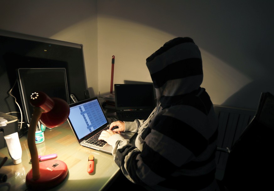epa06053171 A hooded young Croatian computer and IT specialist works on a laptop in downtown Zagreb, Croatia, 27 Jun 2017. According to news reports, companies around the world on 27 June 2017 are rep ...