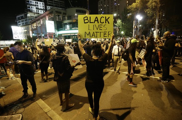 Protesters take to the streets of uptown during a peaceful march following Tuesday&#039;s police shooting of Keith Lamont Scott in Charlotte, N.C., Thursday, Sept. 22, 2016. (AP Photo/Gerry Broome)
