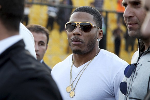 FILE- In March 13, 2015, file photo, rapper Nelly approaches the stage for a concert in Irbil, northern Iraq. Police have arrested Nelly after a woman said he raped her in a town outside Seattle, an a ...