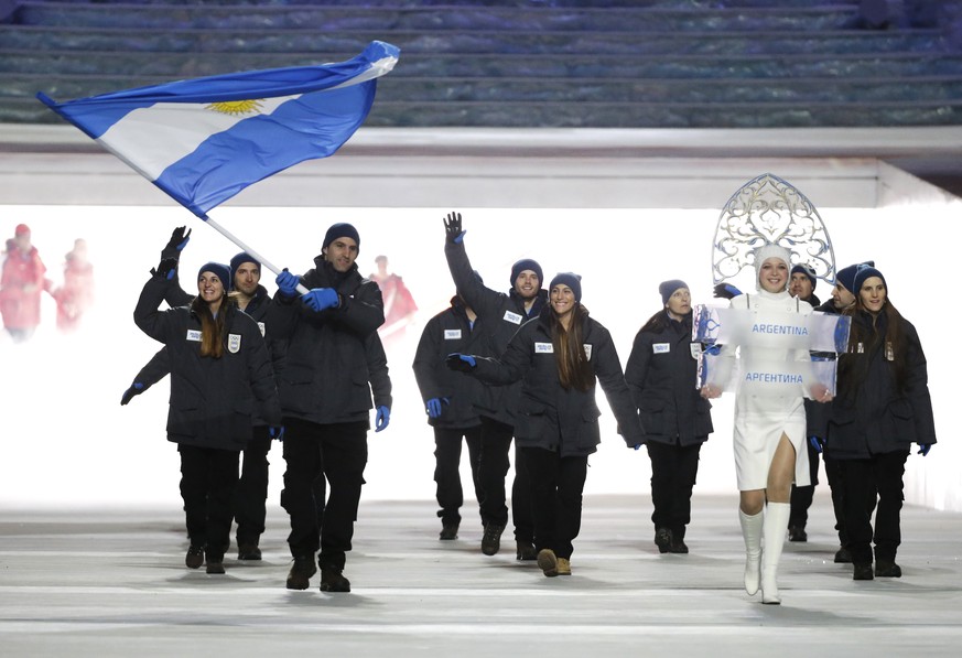 Cristian Simari Birkner of Argentina carries the national flag as he leads the team during the opening ceremony of the 2014 Winter Olympics in Sochi, Russia, Friday, Feb. 7, 2014. (AP Photo/Mark Humph ...