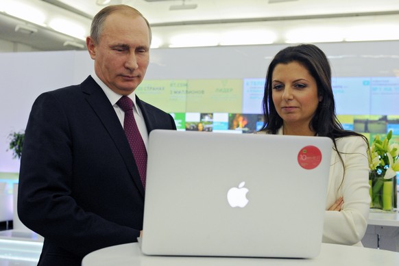 Russian President Vladimir Putin and Editor-in-chief of RT (Russia Today) 24-hour English-language TV news channel, Margarita Simonya, attend an exhibition marking RT&#039;s 10th anniversary in Moscow ...