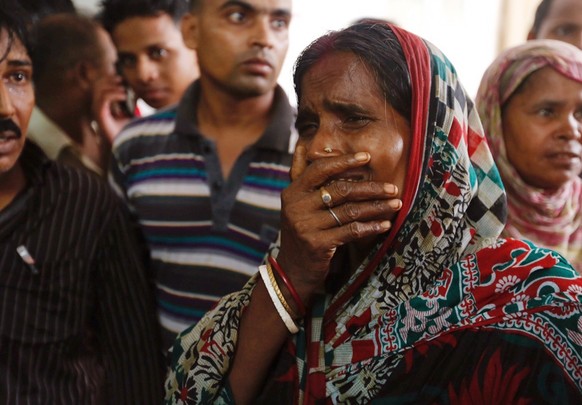 A relative of a fire victim cries as victims&#039; bodies are carried into a makeshift morgue at a hospital after a fire broke out at a packaging factory in Tongi industrial area outside Dhaka, Bangla ...