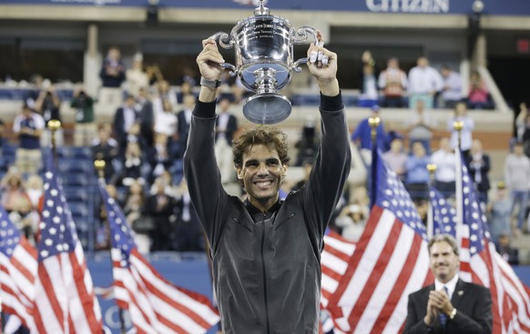 FILE - In this Sept. 9, 2013, file photo, Rafael Nadal, of Spain, holds up the championship trophy after winning the men&#039;s singles final over Novak Djokovic, of Serbia, at the 2013 U.S. Open tenn ...