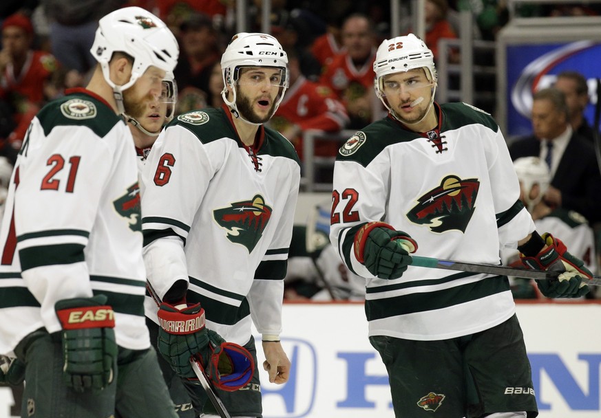 Minnesota Wild&#039;s Marco Scandella (6) talks to Kyle Brodziak (21) and Nino Niederreiter (22) during the second period in Game 2 of an NHL hockey second-round playoff series against the Chicago Bla ...