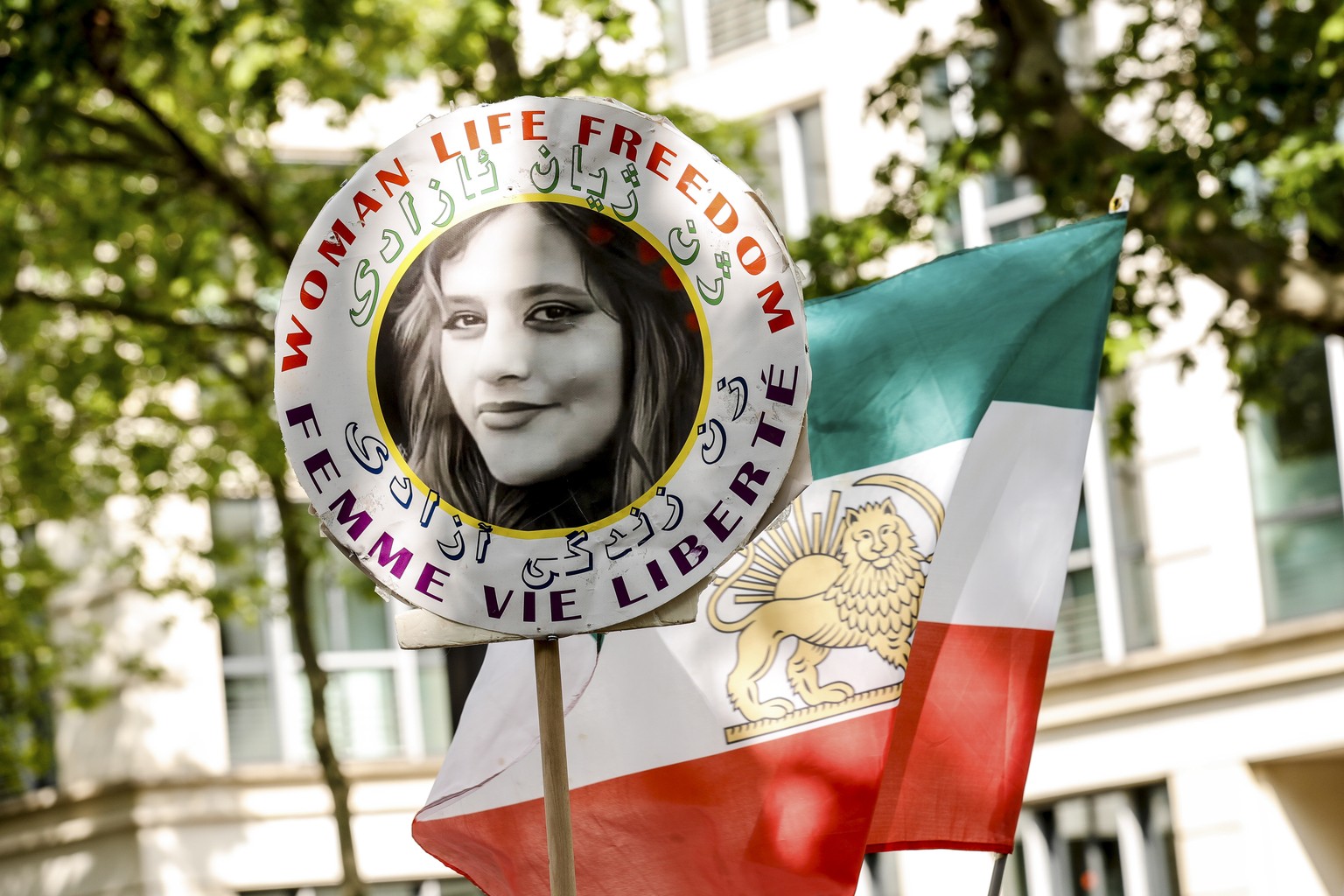 epa10648480 A demonstrator carries the portrait of Mahsa Amini, who died in detention following her arrest by the Iranian morality police in September 2022, during a demonstration near the Iranian emb ...