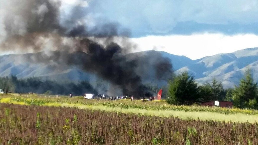 epa05876270 A handout photo made available by the Peruvian National Police shows the site where a Peruvian Airlines plane landed and then burst into flames at the Francisco Carle Airport in Jauja, Per ...