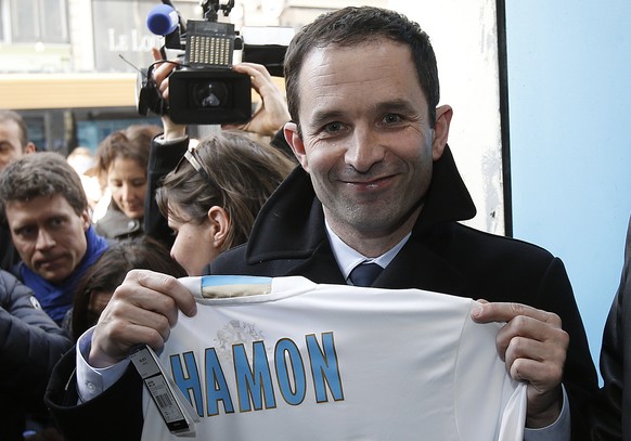 epa05835024 French Socialist Party (PS), candidate for the 2017 French presidential elections, Benoit Hamon (C) holds an Olympique Marseille&#039;s soccer shirt during a presidential campaign visit to ...