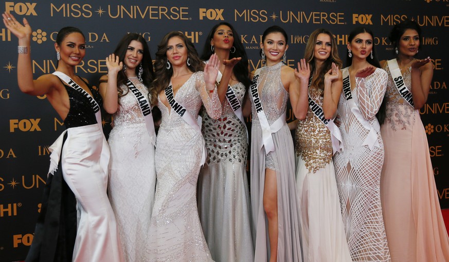 Miss Universe contestants blow kisses to photographers as they pose on the red carpet on the eve of their coronation Sunday, Jan. 29, 2017, at the Mall of Asia in suburban Pasay city south of Manila,  ...