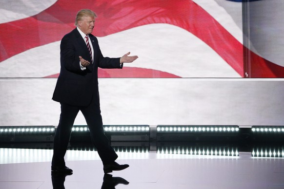 epa05434264 Republican Presidential nominee Donald Trump arrives onstage to join Indiana Governor and Republican Vice Presidential nominee Mike Pence (not pictured) during the third day of the 2016 Re ...