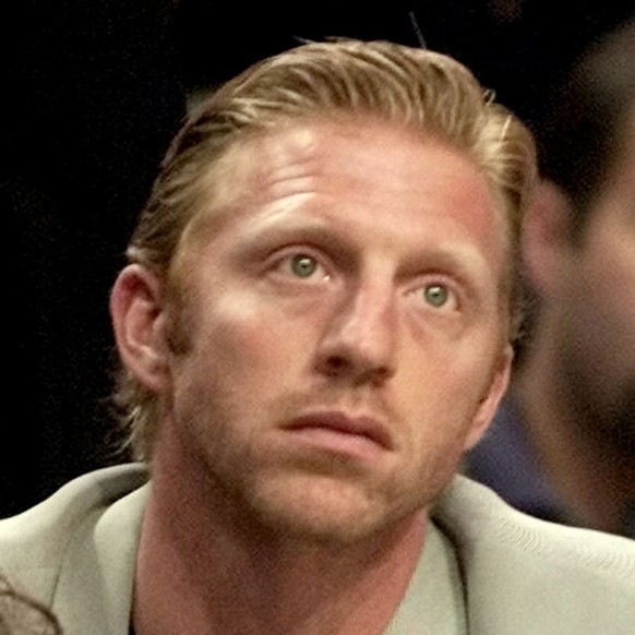 Former German tennis player Boris Becker and Noah, aged 6, one of his two children look on towards the end of a Miami Heat basketball game in this photo taken Saturday, Nov. 4, 2000 at the American Ai ...