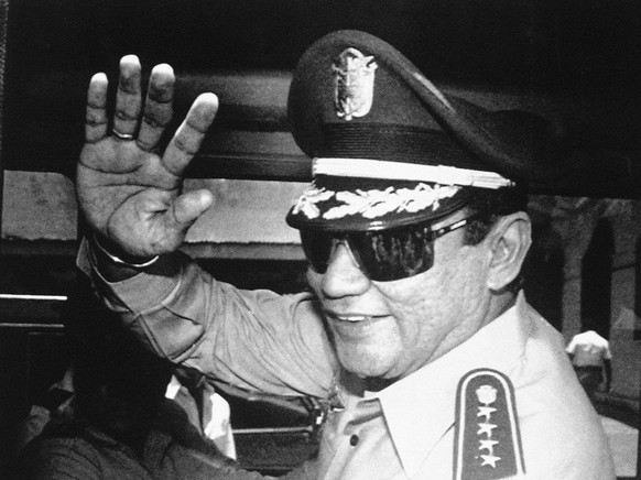 FILE - In this Aug. 31, 1989 file photo, Gen. Manuel Antonio Noriega waves to newsmen after a state council meeting, at the presidential palace in Panama City, where they announced the new president o ...