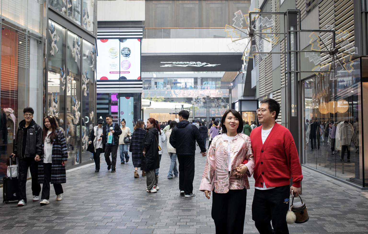 Nachrichten Linkding epa11656834 Shoppers walk at a luxury mall in Beijing, China, 13 October 2024. China's annual inflation rate slowed in September 2024 below market forecasts, falling to 0.4 percent from 0.6 perce ...