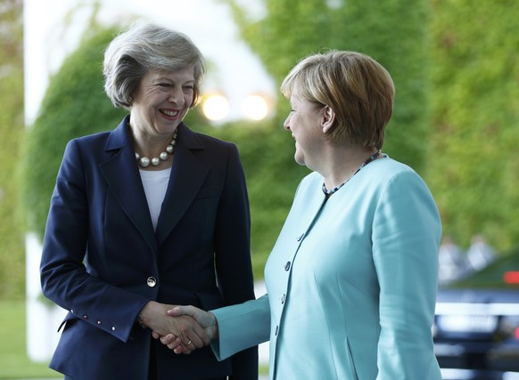 German Chancellor Angela Merkel greets British Prime Minister Theresa May (L) during a welcoming ceremony at the Chancellery in Berlin, Germany July 20, 2016. REUTERS/Hannibal Hanschke