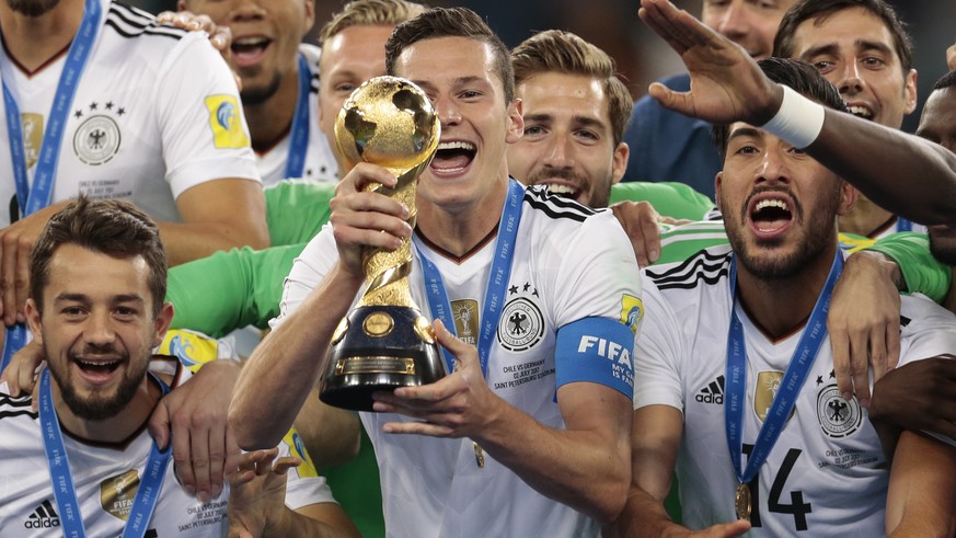 Germany&#039;s Julian Draxler holds up the trophy, at the end of the Confederations Cup final soccer match between Chile and Germany, at the St.Petersburg Stadium, Russia, Sunday July 2, 2017. Germany ...
