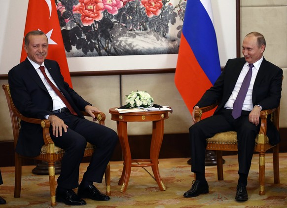 Russian President Vladimir Putin, right, and Turkish President Recep Tayyip Erdogan speak during their meeting ahead of the G20 Summit in Hangzhou, China, Saturday, Sept. 3, 2016.(Yasin Bulbul, Presid ...