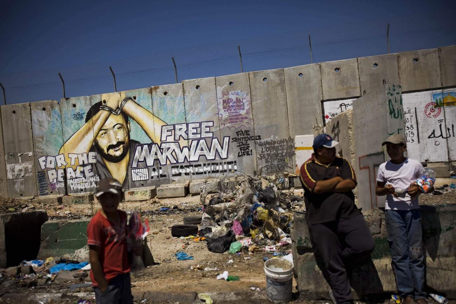 Graffiti of jailed Palestinian Fatah leader Marwan Barghouti is seen on a section of Israel&#039;s separation barrier in the West Bank town of Kalandia, between Jerusalem and Ramallah, Wednesday, Aug. ...