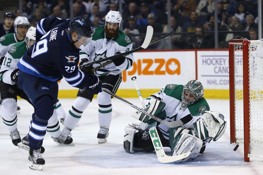 Winnipeg Jets&#039; Patrik Laine (29) scores his second goal of the night against Dallas Stars goaltender Kari Lehtonen (32) as Jordie Benn (24) and Radek Faksa (12) defend during the second period of ...