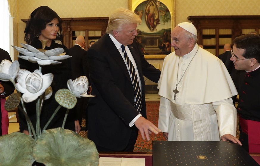 Pope Francis exchanges gifts with President Donald Trump and First Lady Melania Trump, on the occasion of their private audience, at the Vatican, Wednesday, May 24, 2017. (AP Photo/Alessandra Tarantin ...