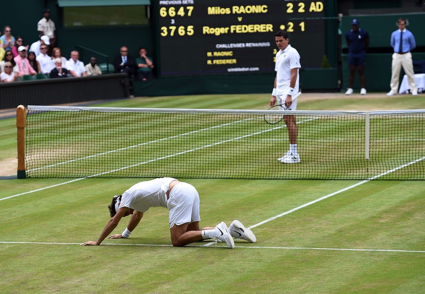 epa05415475 Roger Federer of Switzerland takes a fall as he plays Milos Raonic of Canada in their semi final match during the Wimbledon Championships at the All England Lawn Tennis Club, in London, Br ...