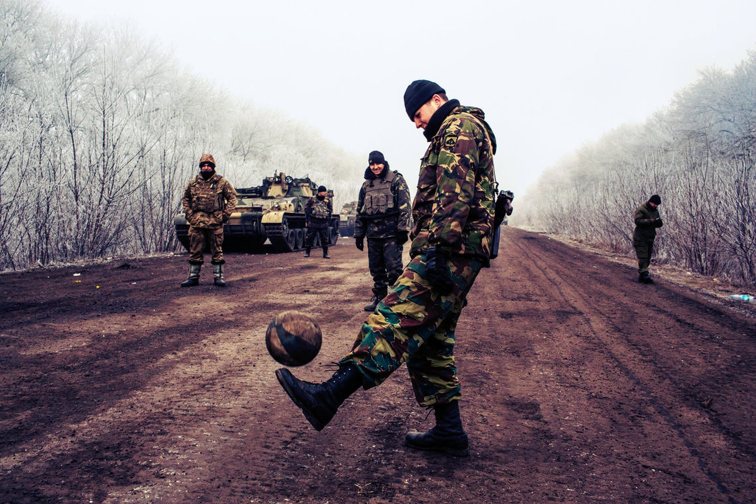 15. Februar 2015: Ein ukrainischer Soldat spielt Fussball auf der Strasse, die nach Debalzewo führt.&nbsp;