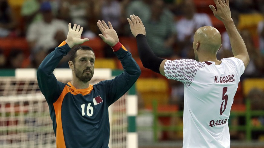 Qatar&#039;s Goran Stojanovic, left, and Qatar&#039;s Marko Bagaric celebrate after winning the men&#039;s preliminary handball match between Qatar and Croatia at the 2016 Summer Olympics in Rio de Ja ...