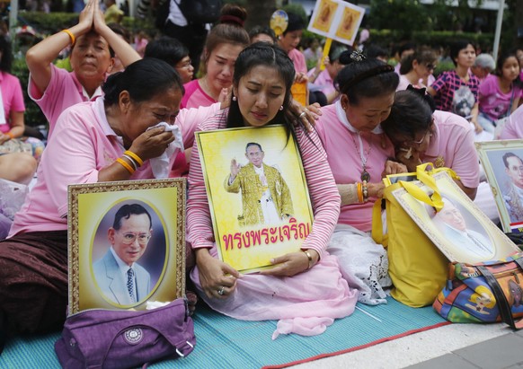 Thais cry as they pray for Thailand&#039;s King Bhumibol Adulyadej at Siriraj Hospital where the king is being treated in Bangkok, Thailand, Thursday, Oct. 13, 2016. The royal palace said in a stateme ...