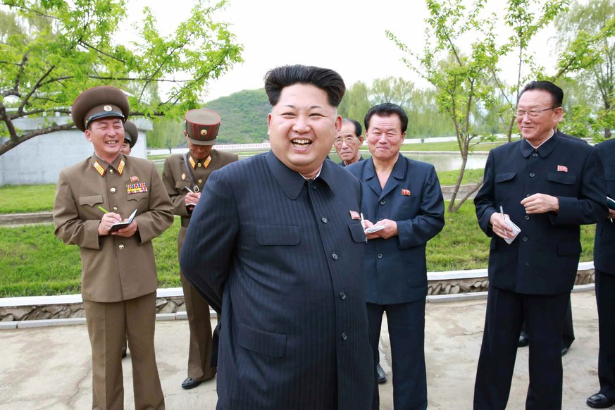 epa04749016 An undated picture released by the Rodong Sinmun, the newspaper of the North Korean ruling Workers Party, on 15 May 2015 shows North Korean leader Kim Jong-un (front) inspecting a fish far ...