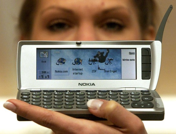 A model displays Nokia&#039;s new mobile phone 9210 Communicator prior to its launch at the computer fair &quot;CeBIT 2001&quot; in Hanover, March 21, 2001. The 9210 has colour display and multi-media ...