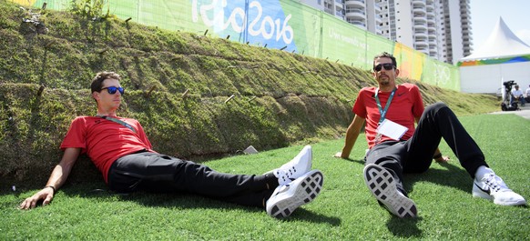 Sebastien Reichenbach, left, and Steve Morabito, right, cyclists of Switzerland, relax during the welcome ceremony of the Team Switzerland in the Olympic Media Village in Rio de Janeiro, Brazil, prior ...