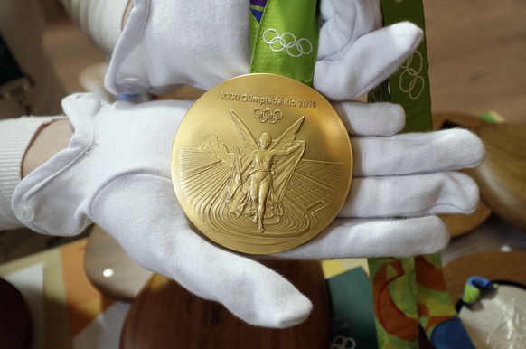 A Rio 2016 Olympic gold medal is displayed at the Olympic Park Wednesday, July 20, 2016, in Rio de Janeiro. There&#039;s no such thing as a gold medal, not at these upcoming Rio Olympics, and really,  ...