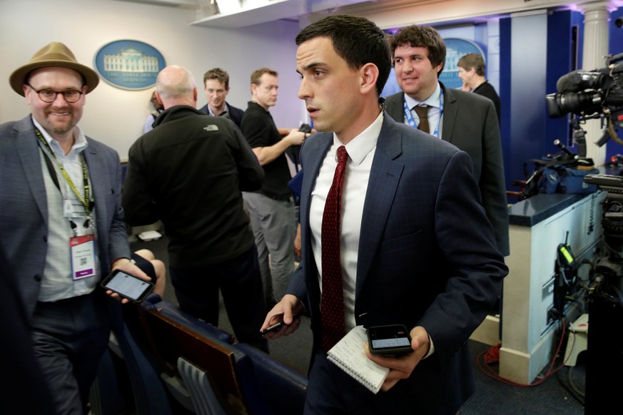 Journalists leave after several major news organizations including CNN, The New York Times and Politico were excluded from an off camera &quot;gaggle&quot; meeting with White House Press Secretary Sea ...