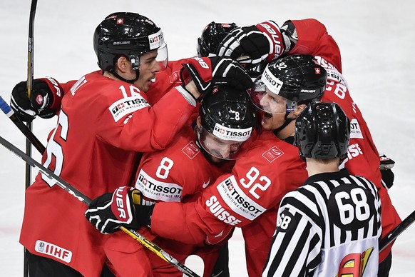 Switzerland’s Rafael Diaz, Vincent Praplan and Gaetan Haas, from left, celebrate their second goal during their Ice Hockey World Championship group B preliminary round match between Switzerland and Fr ...