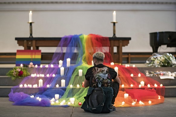 epa05362268 A Swiss LGBT activists places a candle during a vigil for the victims of a mass shooting in Orlando, USA on 12 June, at a church in Zurich, Switzerland, 13 June 2016. A total of 50 people  ...