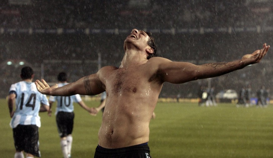 In this two picture combo, Boca Juniors&#039; Martin Palermo shows off to fans a poncho made by children from the soccer club after he played his last game at La Bombonera stadium, an Argentine league ...