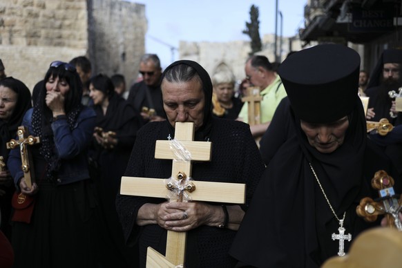 Christian pilgrims attend Good Friday procession in Jerusalem Friday, April 14, 2017. Good Friday is a Christian holiday which marks the crucifixion of Jesus Christ and his death. (AP Photo/Dan Balilt ...