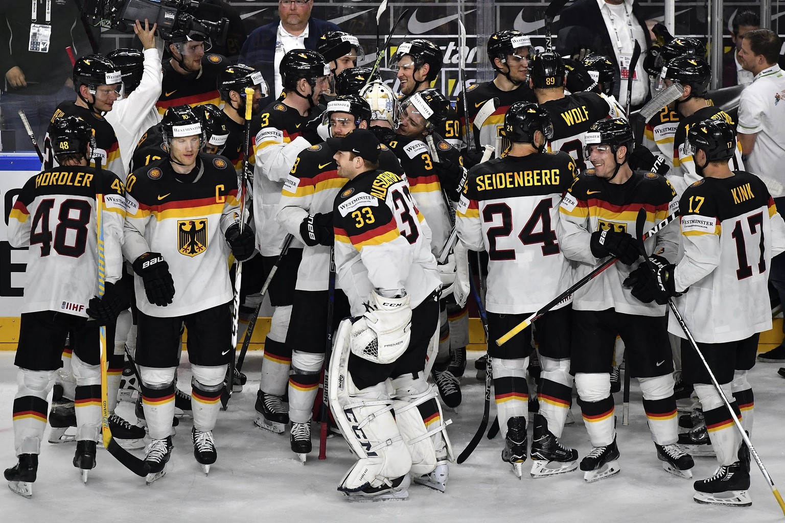 epa05968555 Players of Germany celebrate after winning their 2017 IIHF Ice Hockey World Championship group A preliminary round match between Germany and Latvia in Cologne, Germany, 16 May 2017. EPA/SA ...