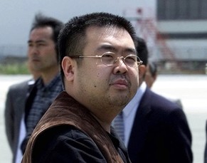 FILE - In this May 4, 2001, file photo, a man believed to be Kim Jong Nam, the eldest son of then North Korean leader Kim Jong Il, looks at a battery of photographers as he exits a police van to board ...