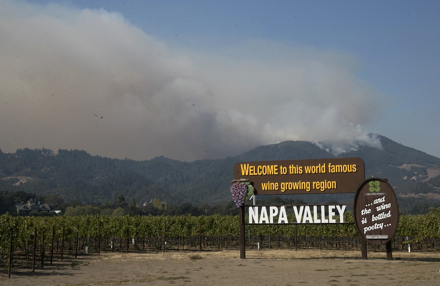 Smoke billows from a fire burning in the mountains over Napa Valley, Friday, Oct. 13, 2017, in Oakville, Calif. Firefighters gained some ground on a blaze burning in the heart of California&#039;s win ...