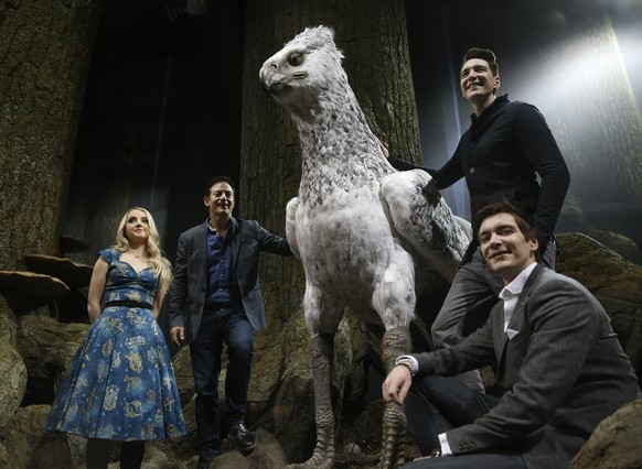 Actoress Evanna Lynch, left with Jason Isaacs, James Phelps and his brother Oliver, front right, pose for the media next to Buckbeak at a new extension called the &#039;Forbidden Forest&#039; to the W ...