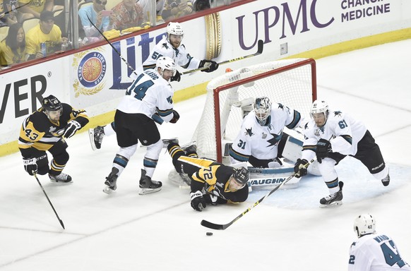 Die Penguins (dunkel) und die Sharks (hell) geben in NHL-Final alles.