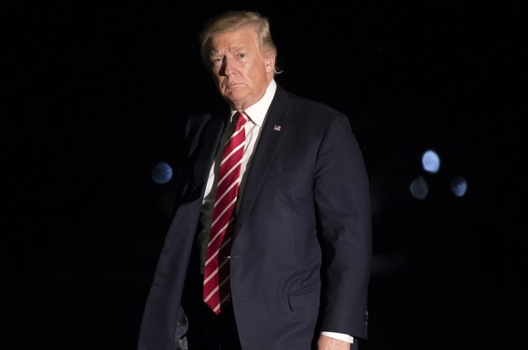 epa06251525 US President Donald J. Trump walks to the residence after stepping off Marine One on the South Lawn of the White House in Washington, DC, USA, 07 October 2017. President Trump traveled to  ...