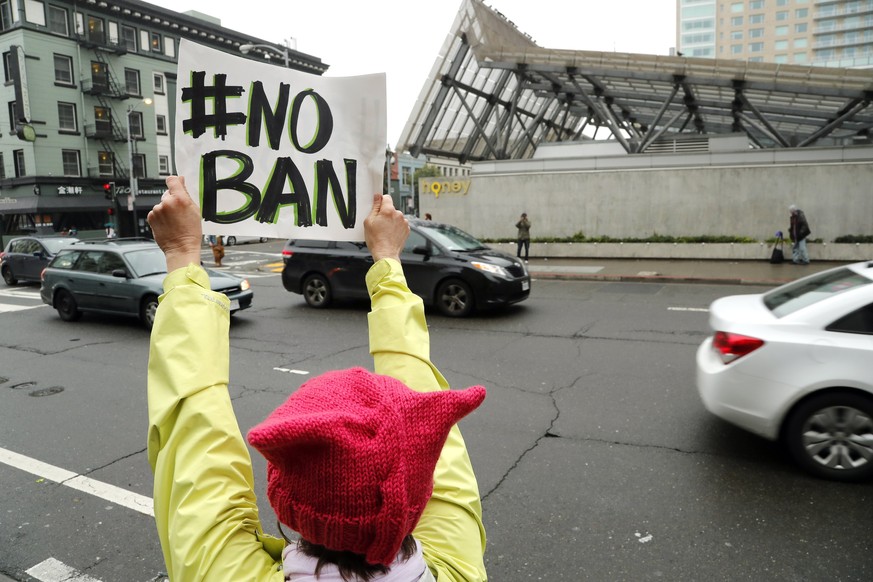epa05777346 An anti-travel ban protestor with a poster reading &#039;NO BAN&#039; stands outside the Ninth US Circuit Court of Appeals as three-judge federal appeals panel from the court scheduled a h ...